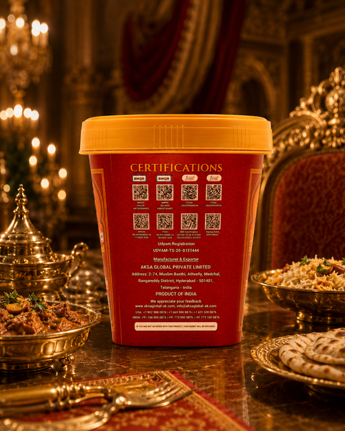 Hyderabadi Ghee's food container with a yellow lid stands on a decorated table in a warm, ornate indoor setting. The back of the container is printed with certification QR codes and text, and the scene includes silver serving dishes and a red upholstered chair in the background.